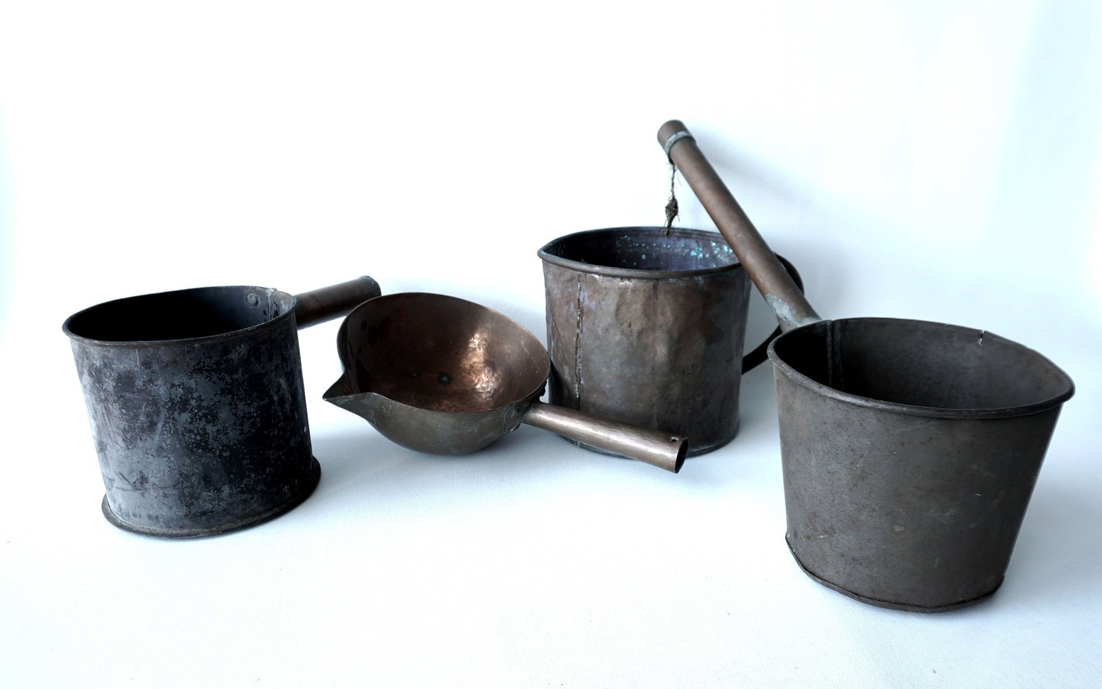 Grouping of 4 blubber pails, all 19th century, and presumingly once had long wooden handles which: Grouping of 4 blubber pails, all 19th century, and presumingly once had long wooden handles which are absent. Includes: 1 in hand hammered copper with pouring spout; 2 in tin with copper handles; and 