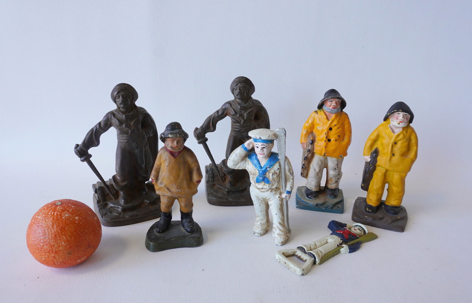 Grouping of cast iron sailor and pirate figures, including: Old Salt bookends in original paint -: Grouping of cast iron sailor and pirate figures, including: Old Salt bookends in original paint - one slightly larger than the other and measures 6 5/8"H; a small similar Old Salt figure, probably a p