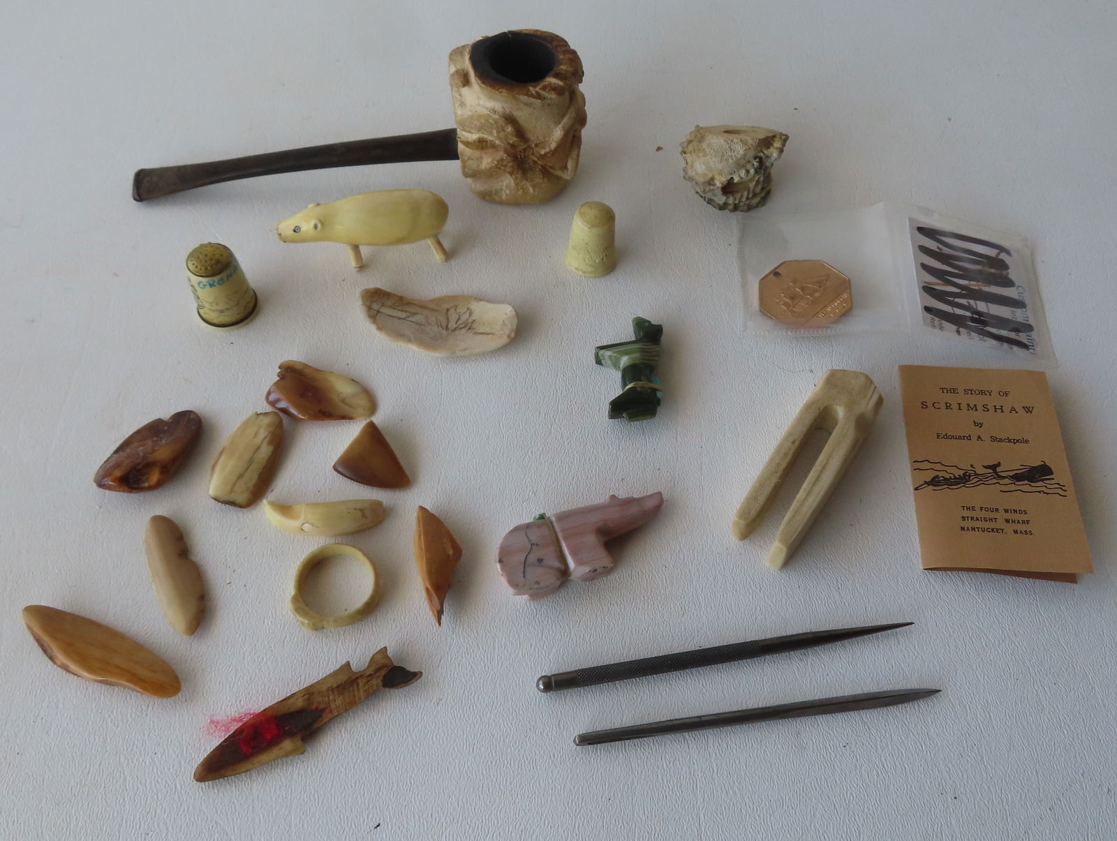 Grouping of mostly miniature maritime related collectibles including resin whale carving - 2 1/4"L,: Grouping of mostly miniature maritime related collectibles including resin whale carving - 2 1/4"L, various polished stones, 2 shark teeth, a small scrimshaw seashell, 2 resin sewing thimbles, tiny In