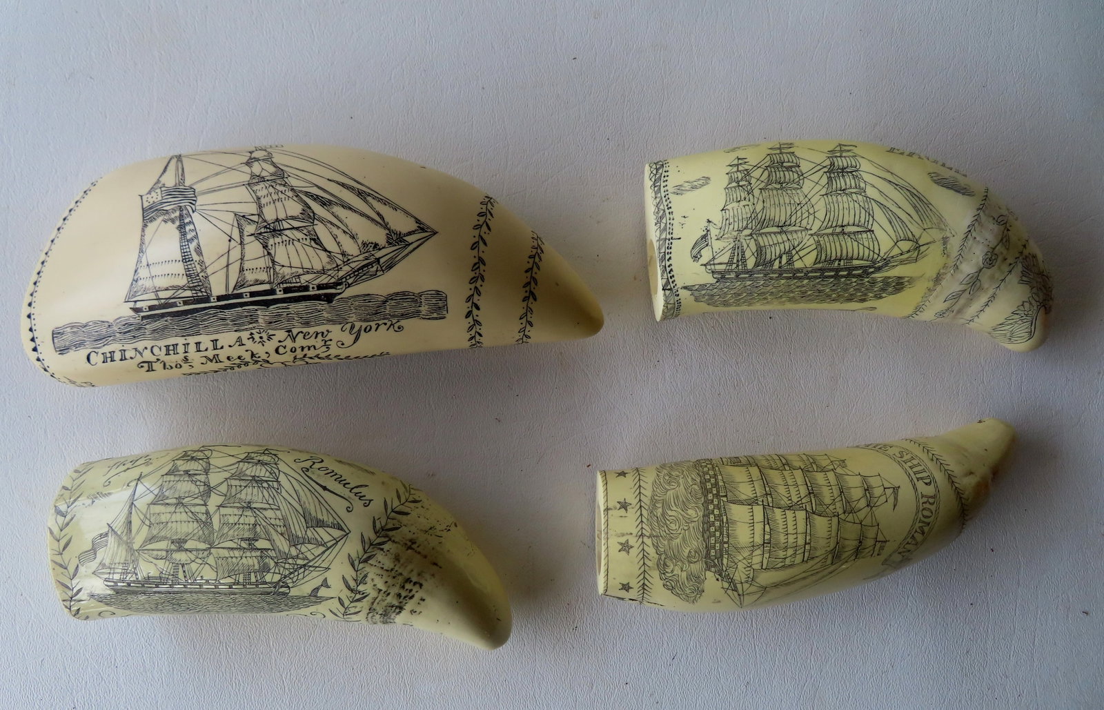 Grouping of 4 reproduction resin scrimshaw whale teeth, one signed J.A. depicting sailing ship and: Grouping of 4 reproduction resin scrimshaw whale teeth, one signed J.A. depicting sailing ship and Lady Liberty waving American flag, another with 2 American whalers signed PMS Artek, and 2 others not