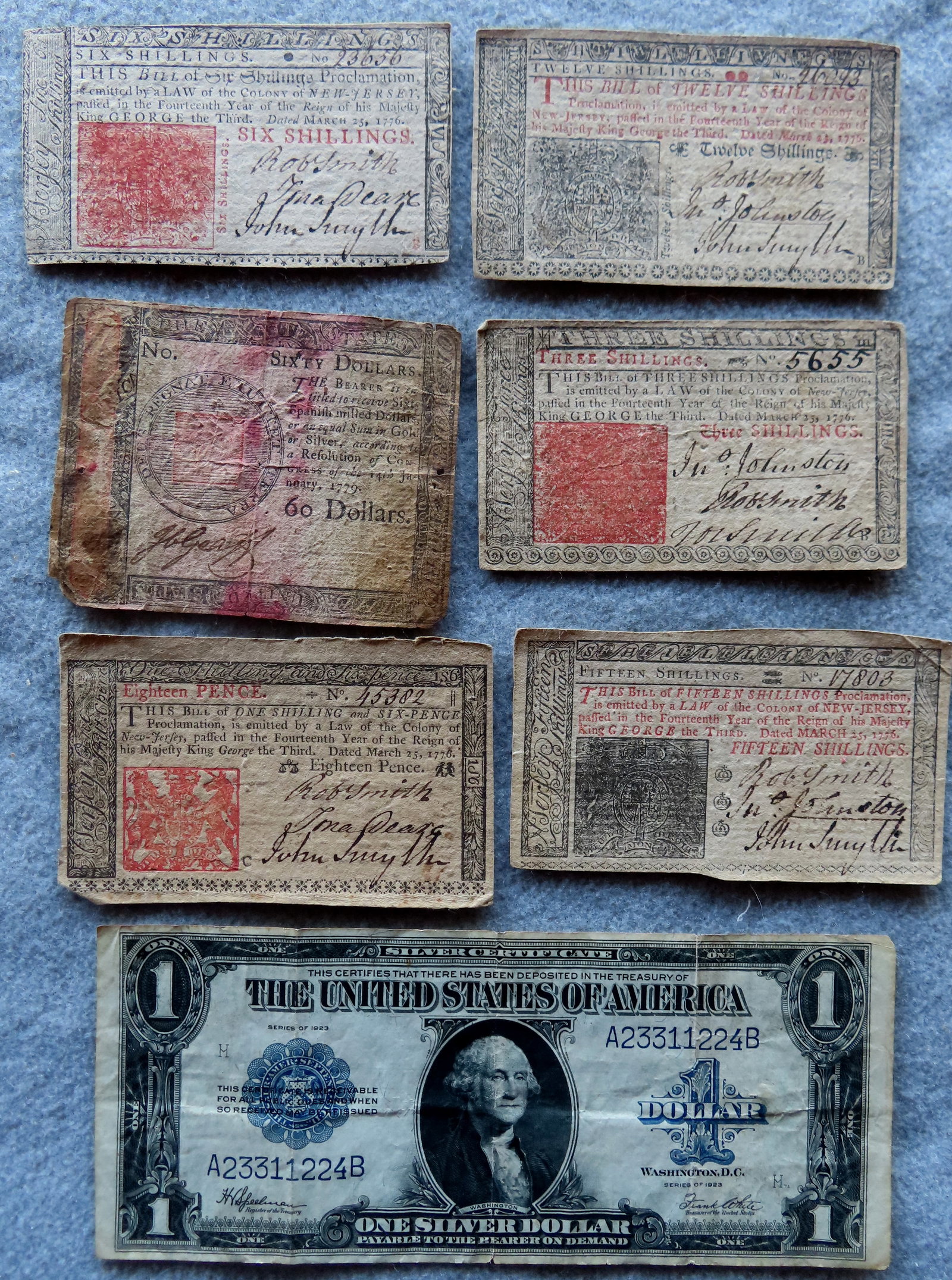 Grouping of 6 pieces of colonial currency including: Sixty Dollars, printed by Hall and Sellers 1779: Grouping of 6 pieces of colonial currency including: Sixty Dollars, printed by Hall and Sellers 1779 - well centered, wear in corners and some staining; Three Shillings, printed by Isaac Collins, 1776