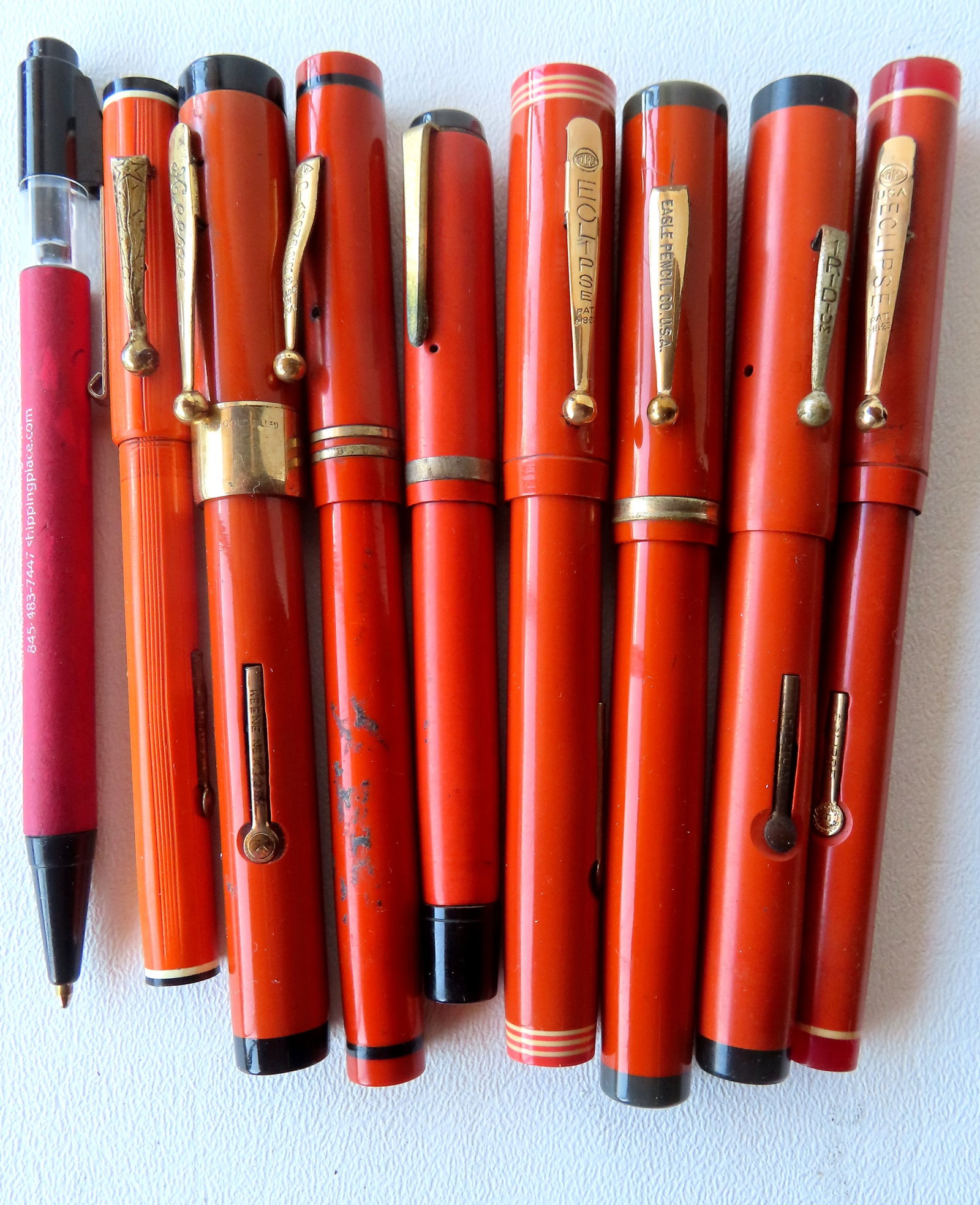 Grouping of 8 vintage orange colored fountain pens by various makers, including: Diamond with 14k: Grouping of 8 vintage orange colored fountain pens by various makers, including: Diamond with 14k nib, 2 Eclipse with 14k nib, Keene NY with 14k nib, Eagle Pencil Co. with 14k nib, Iridium, and 2 unma