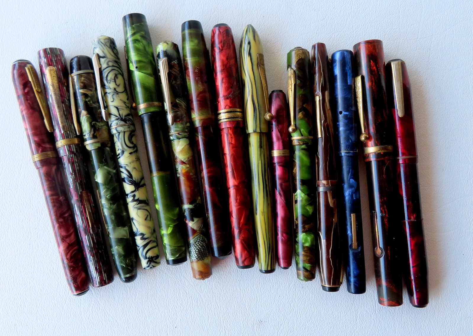 Grouping of 15 vintage fountain pens, all with marbled surfaces, by various makers, including:: Grouping of 15 vintage fountain pens, all with marbled surfaces, by various makers, including: Nasco, Parkette, Wearever, Mabie Todd & Co. - Pat. May 21-18; Wasp Vacuum Fil; Monitor; "The Lincoln Pen"