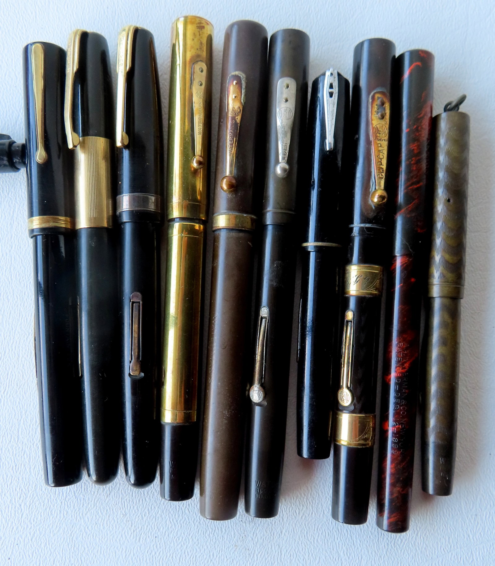 Grouping of 10 Waterman's fountain pens including: Waterman's "Modern" patent Dec. 12 1899 - some: Grouping of 10 Waterman's fountain pens including: Waterman's "Modern" patent Dec. 12 1899 - some surface scratches; Waterman's Ideal with engraved gold plated band; Waterman's with wide gold plated b