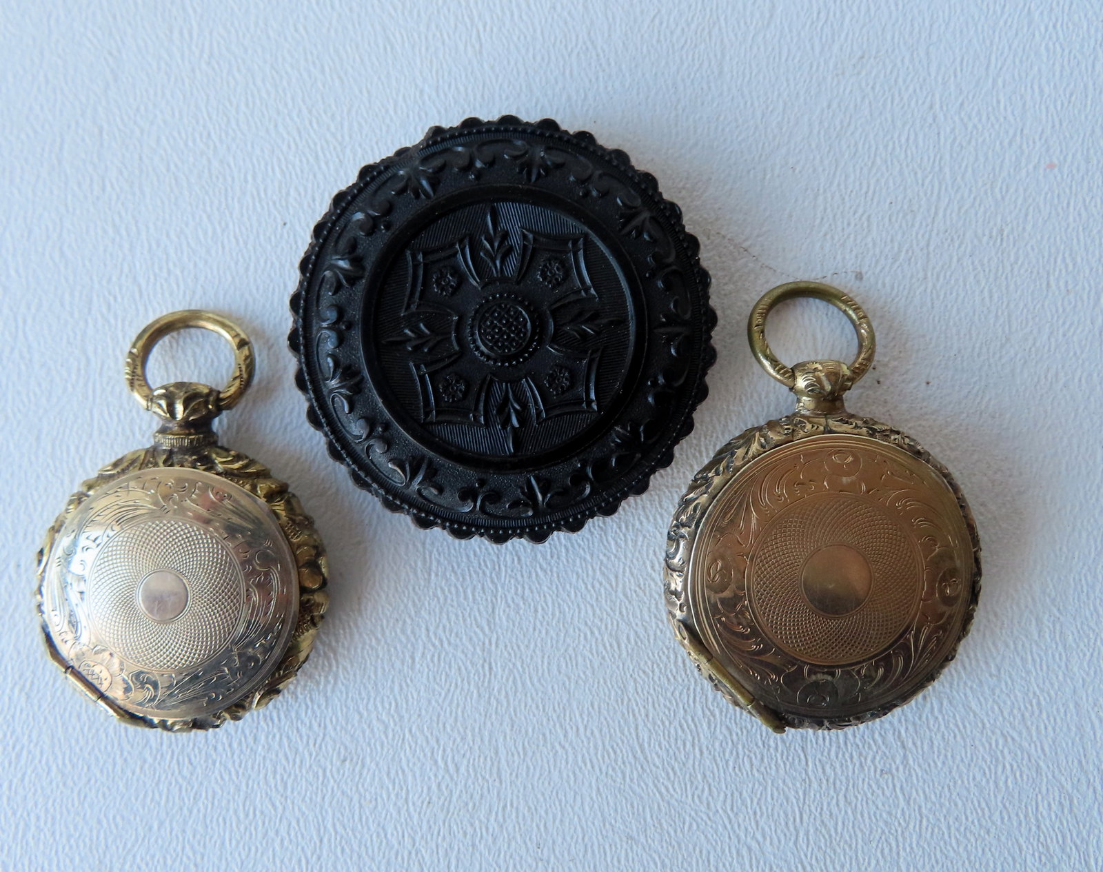 Three pieces of remembrance and mourning jewelry, all circa 1860's, including: A double hinged gold: Three pieces of remembrance and mourning jewelry, all circa 1860's, including: A double hinged gold locket with an early photograph (poor condition) on one side and a braided hair memorial on the othe