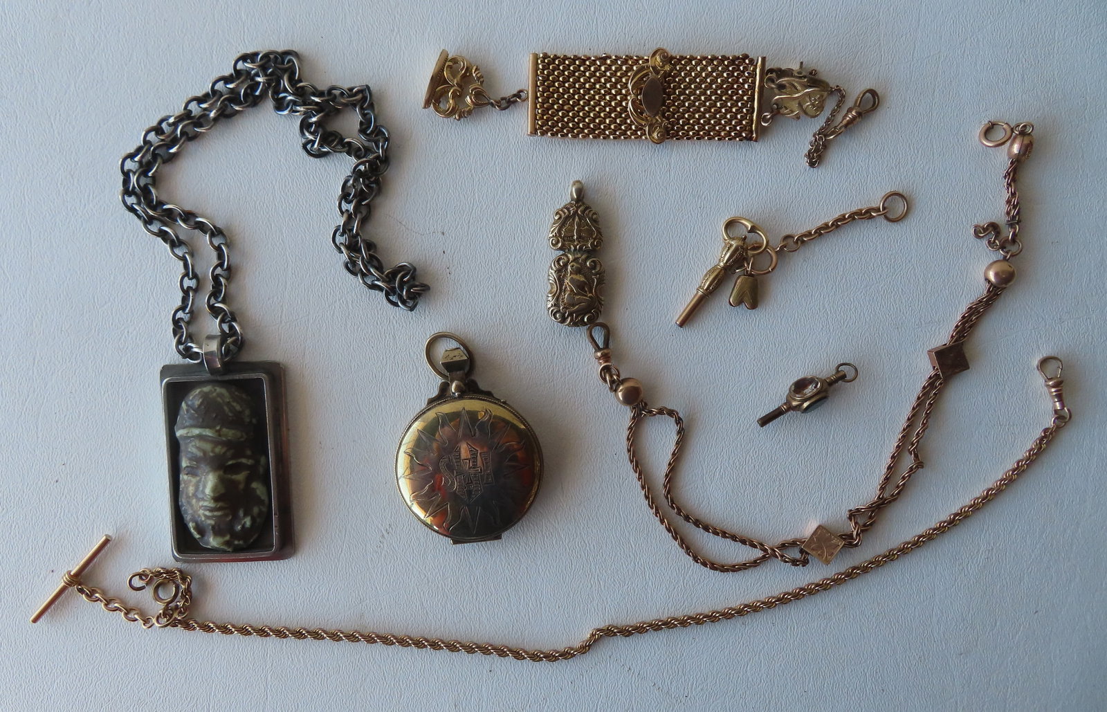 Grouping of vintage jewelry and silver accessories including: Sterling silver Holy Communion case: Grouping of vintage jewelry and silver accessories including: Sterling silver Holy Communion case with gold wash interior - 1 3/4" diameter; an unusual metal pendant with a painted porcelain face atta