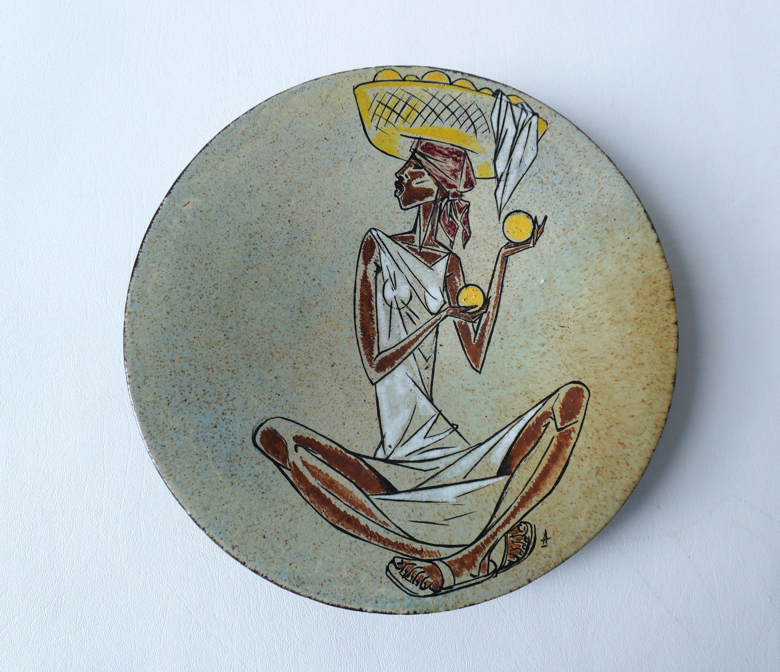 Walter Addison, New York, 1914-1982. A hand painted terra cotta footed plate decorated with southern: Walter Addison, New York, 1914-1982. A hand painted terra cotta footed plate decorated with southern island's lady holding oranges in hands and a basket of oranges on head, signed Addison - very good 