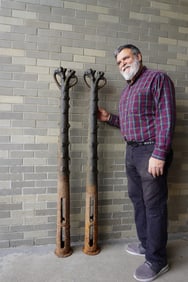 Two matching early cast iron rustic horse hitching posts in the form of a trimmed tree branch with