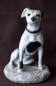 A crushed stone sitting dog lawn ornament in the form of a Jack Russell Terrier. Original paint but