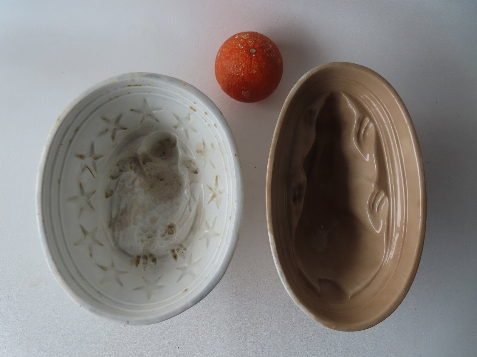 Two ironstone jello molds, one in the form of a spread wing eagle and the other a rabbit, both 19th: Two ironstone jello molds, one in the form of a spread wing eagle and the other a rabbit, both 19th century and in good condition. The largest measures 9"L x 3 1/2"H x 7 1/4"W.