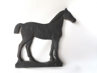 A cast iron horse windmill weight with embossed illegible number on the side of the horse possibly