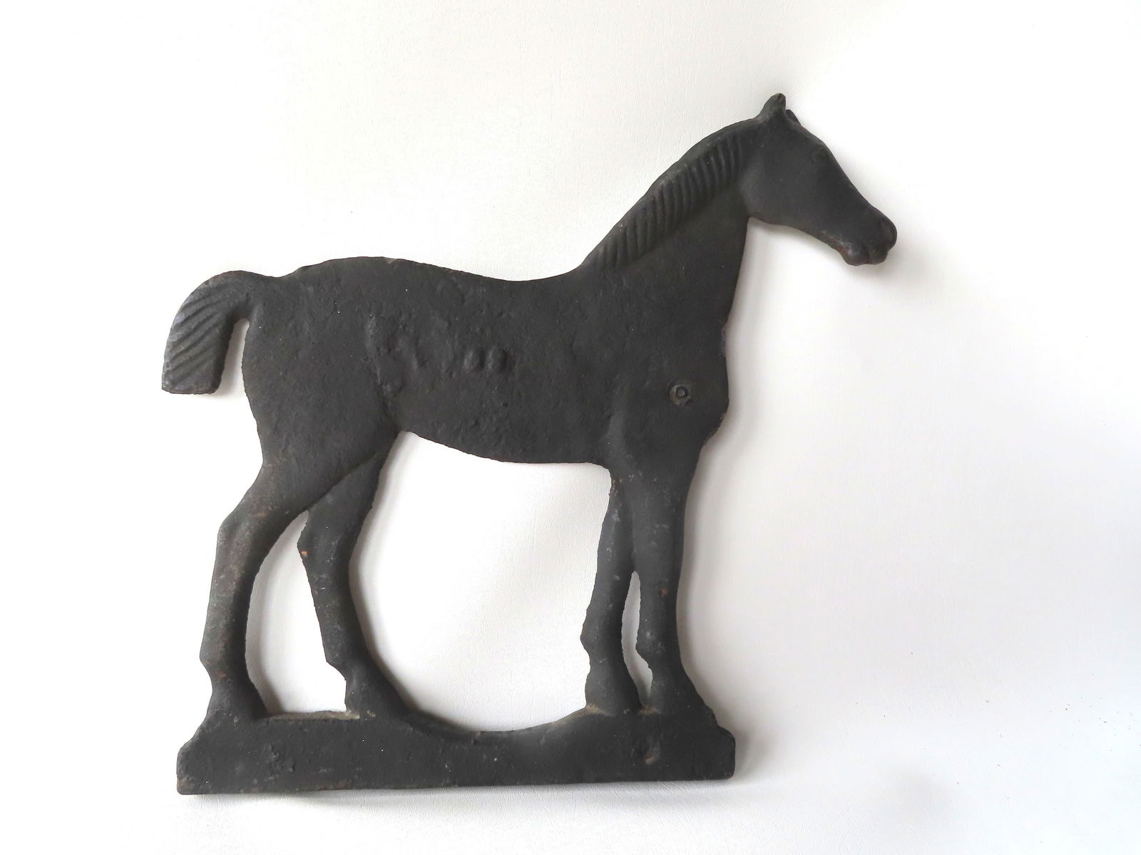 A cast iron horse windmill weight with embossed illegible number on the side of the horse possibly (1 of 5)