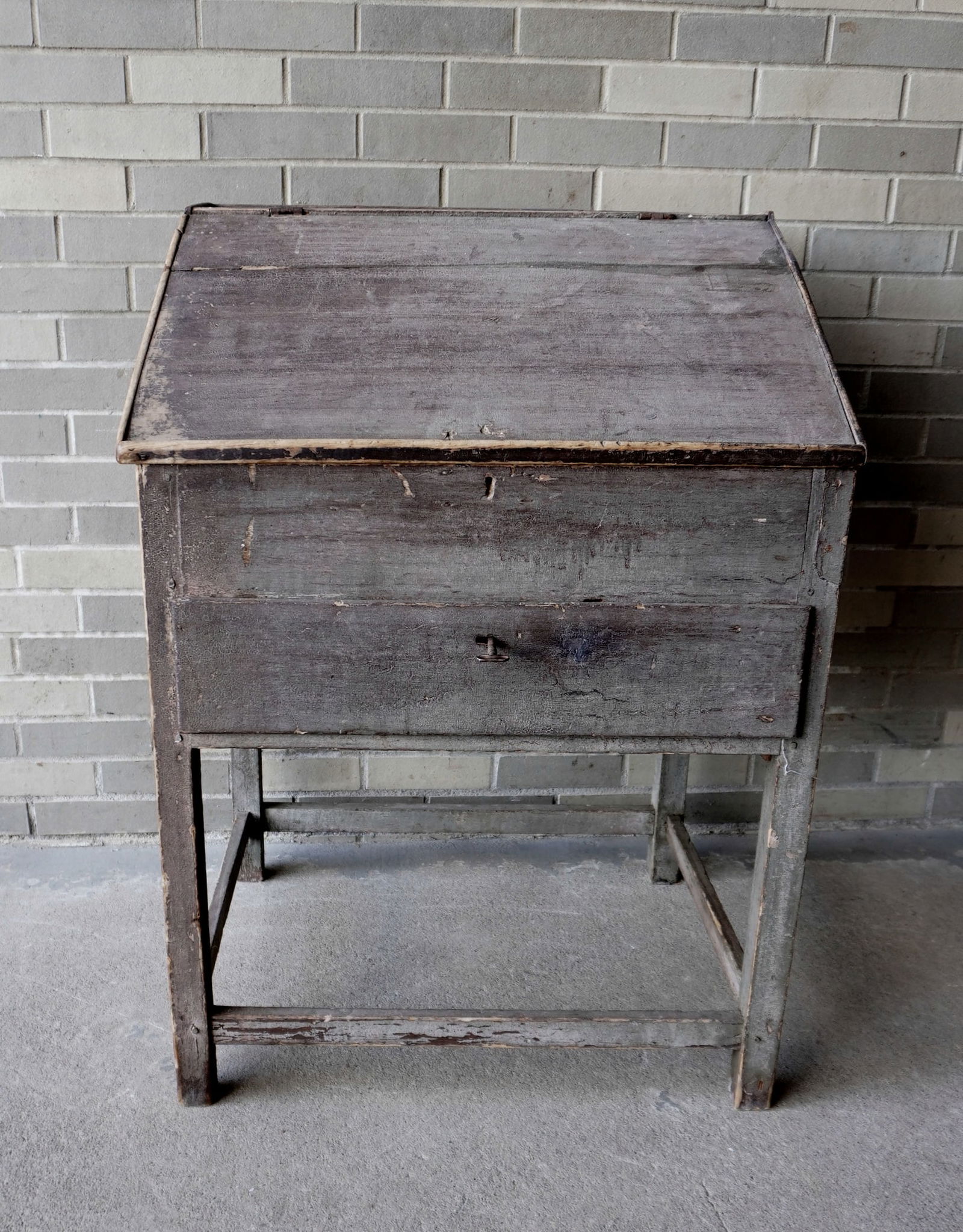 A primitive country store desk in original blue-green paint having a stretcher base, lift top with (1 of 9)