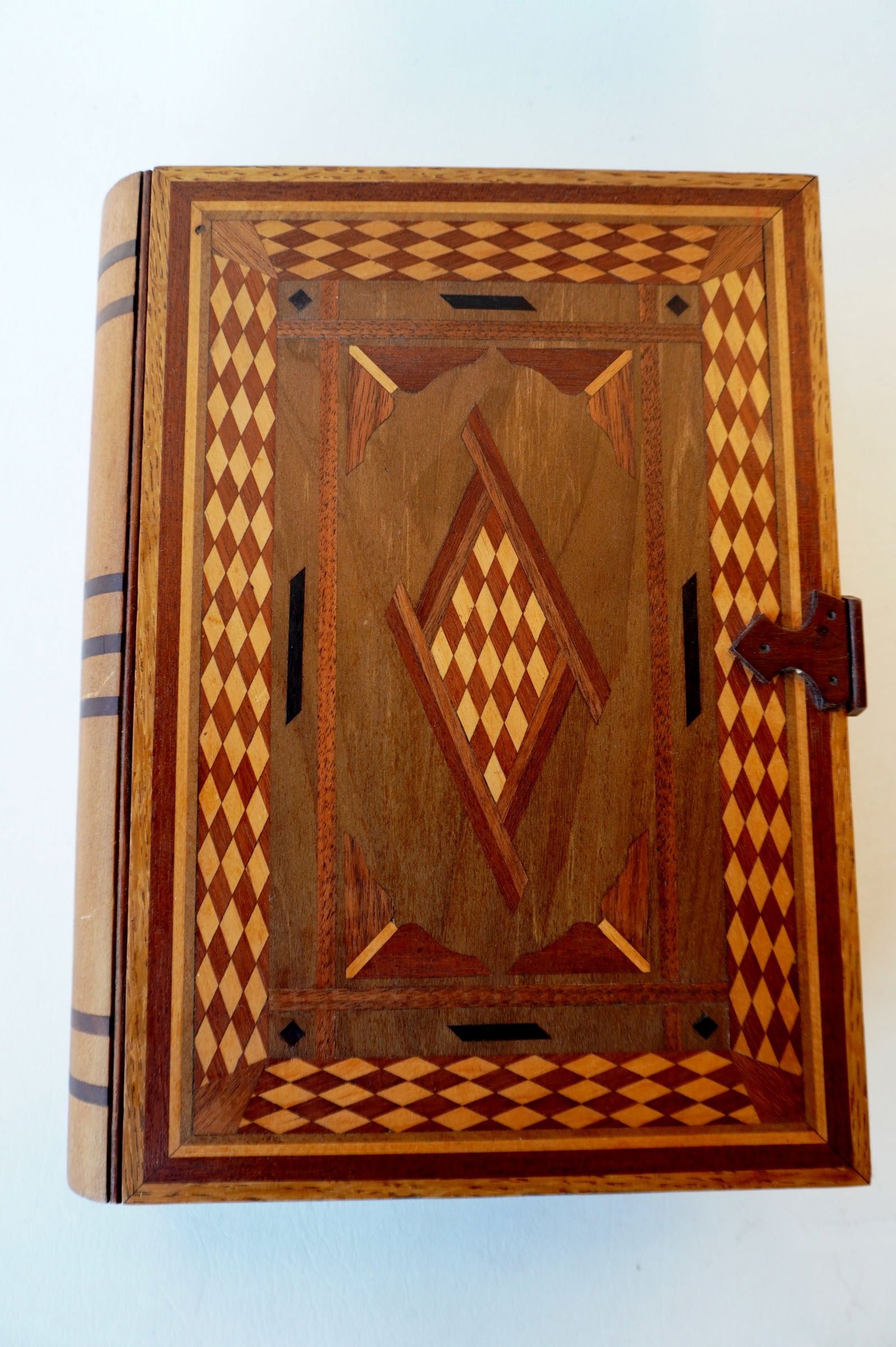 A folk art wooden book shaped valuables box with extensive inlays and secret drawer - the pages in (1 of 8)
