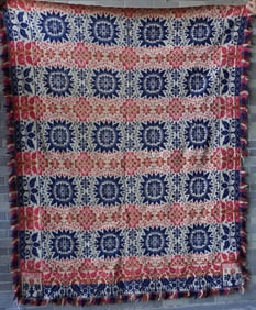 A Jacquard floral tri-color coverlet, having a border decorated with birds, trees and flowers -