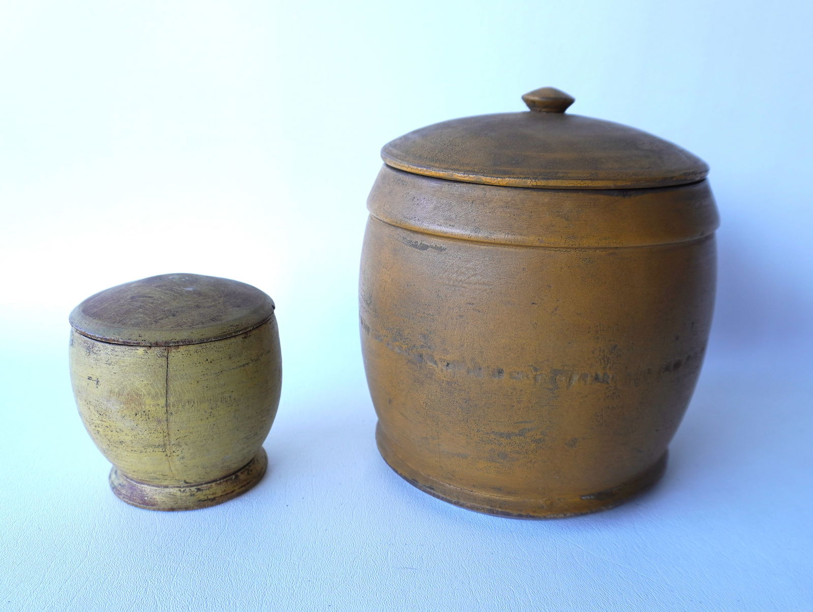 Two  treenware turned canisters in old paint, 19th century. The first, a covered sugar bowl with (1 of 15)