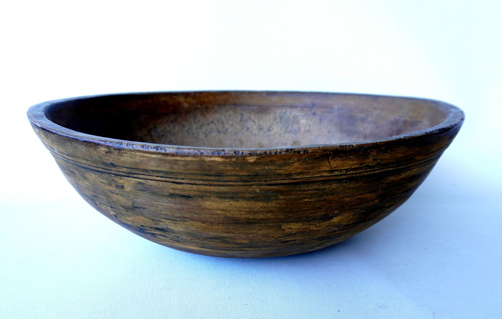 A treenware bowl with an unusual stepped molded rim, and scraped down to original mustard paint. (1 of 14)