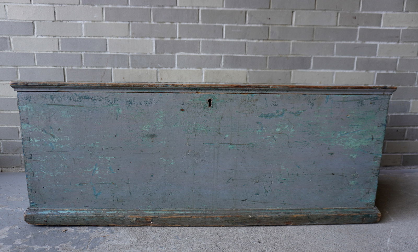 A good blanket box in old blue/gray paint over blue, with rattail hinges and interior till and: A good blanket box in old blue/gray paint over blue, with rattail hinges and interior till and molded base, original lock and hasp (no key), circa 1800. Use wear to lid, otherwise good overall conditi