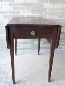 A mahogany Hepplewhite drop leaf table with drawer and original brass pull, circa 1810, single board