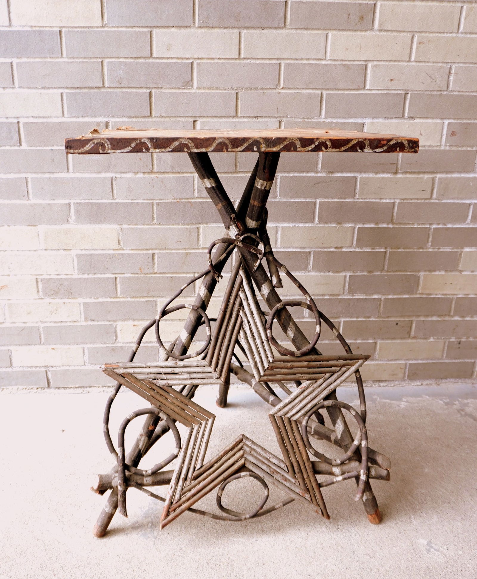 An Adirondack twig stand with original silver painted highlights and having one side decorated with (1 of 8)