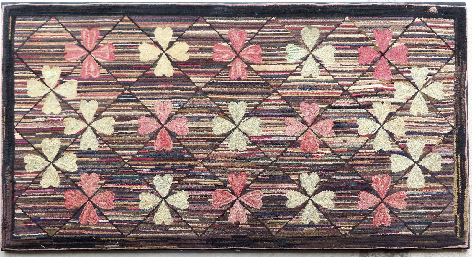 A large mounted hooked rug decorated with flowers with striated background, late 19th to early 20th (1 of 4)