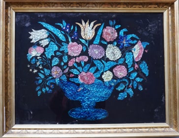 A very fine reverse painted tinsel painting depicting flowers in urn and housed in original lemon