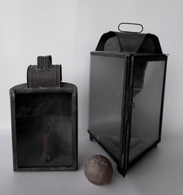 Two early tin candle lighting devices, one triangular shaped with wall mounts and carrying handle -