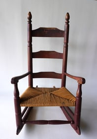 A child's ladder back rocker in original red paint, late 18th century. Replaced rush seat but
