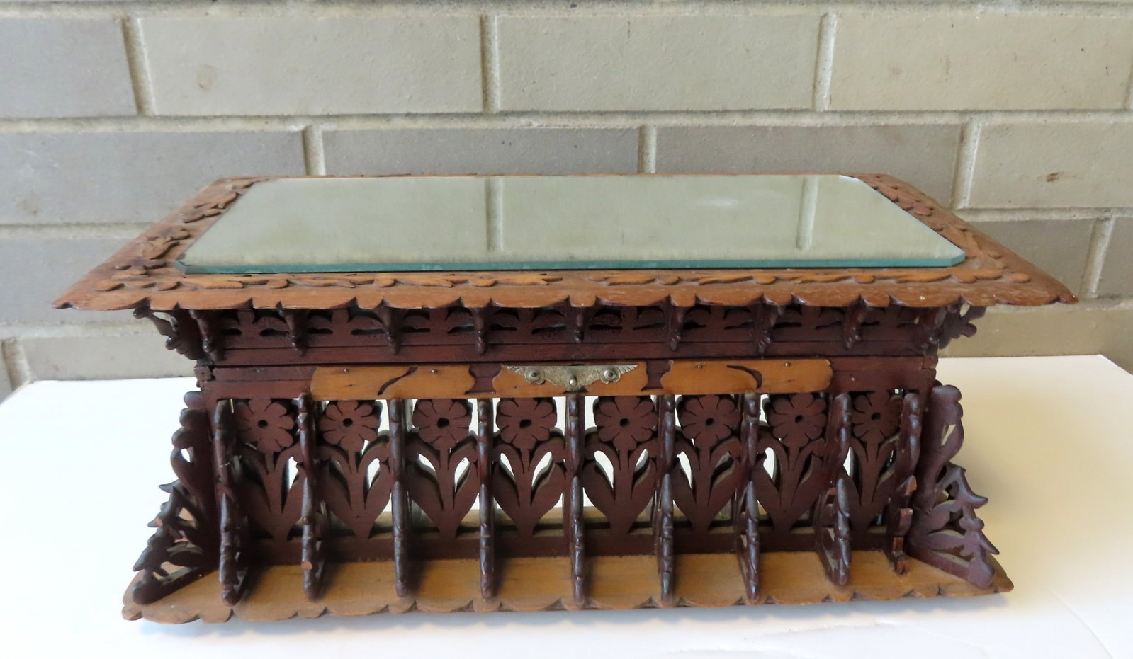 A curious lady's folk art dresser box with extensive floral fretwork around the lid and body, late: A curious lady's folk art dresser box with extensive floral fretwork around the lid and body, late 19th century. The interior has been replaced with newer fabric, and the lid with newer mirror top, so