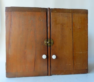 A 2 door hanging pine cupboard. The doors with breadboard ends with original brass inset latch -