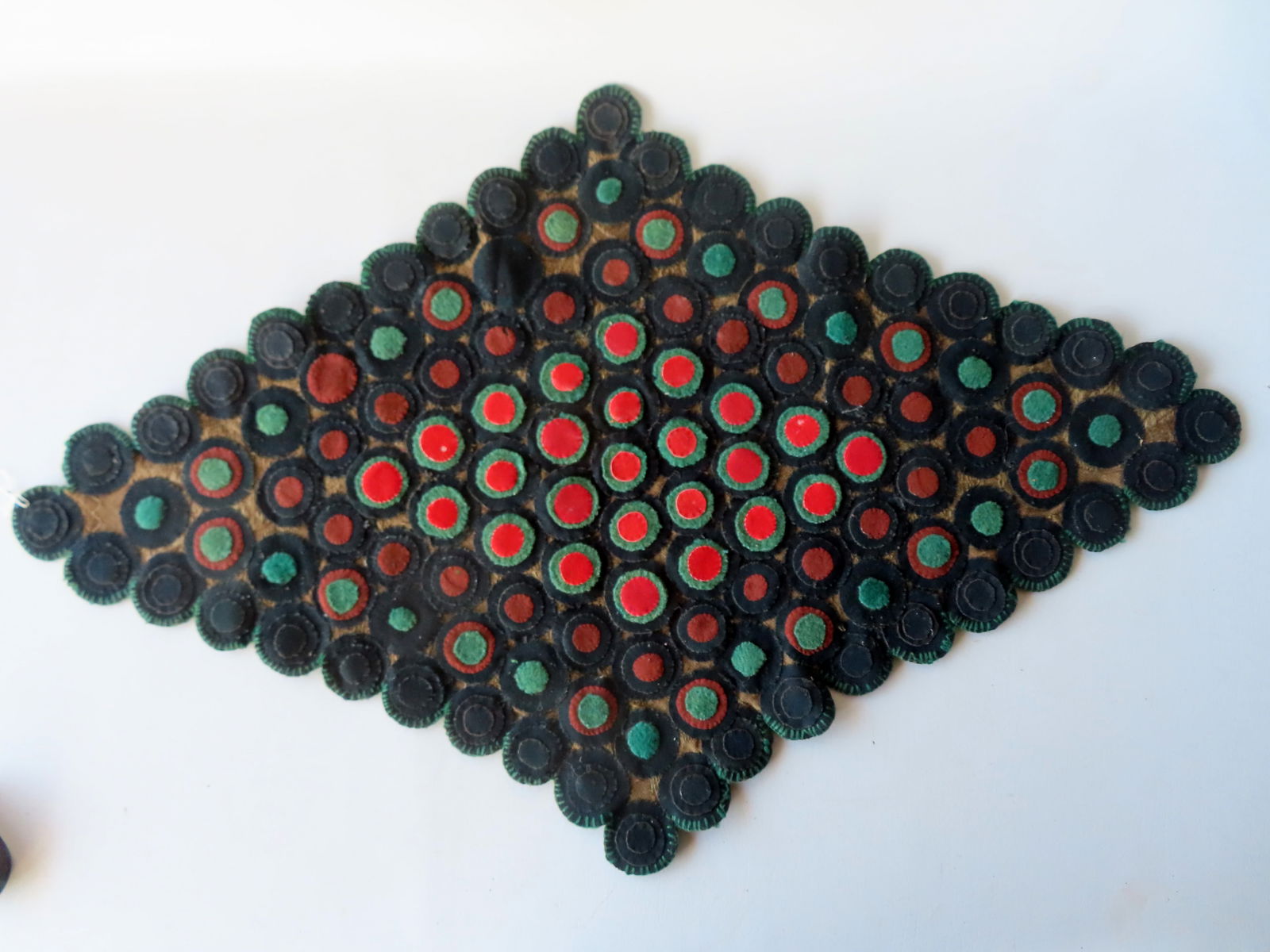 An early table penny rug, all hand sewn, constructed with concentric felt circles sewn to homespun (1 of 10)