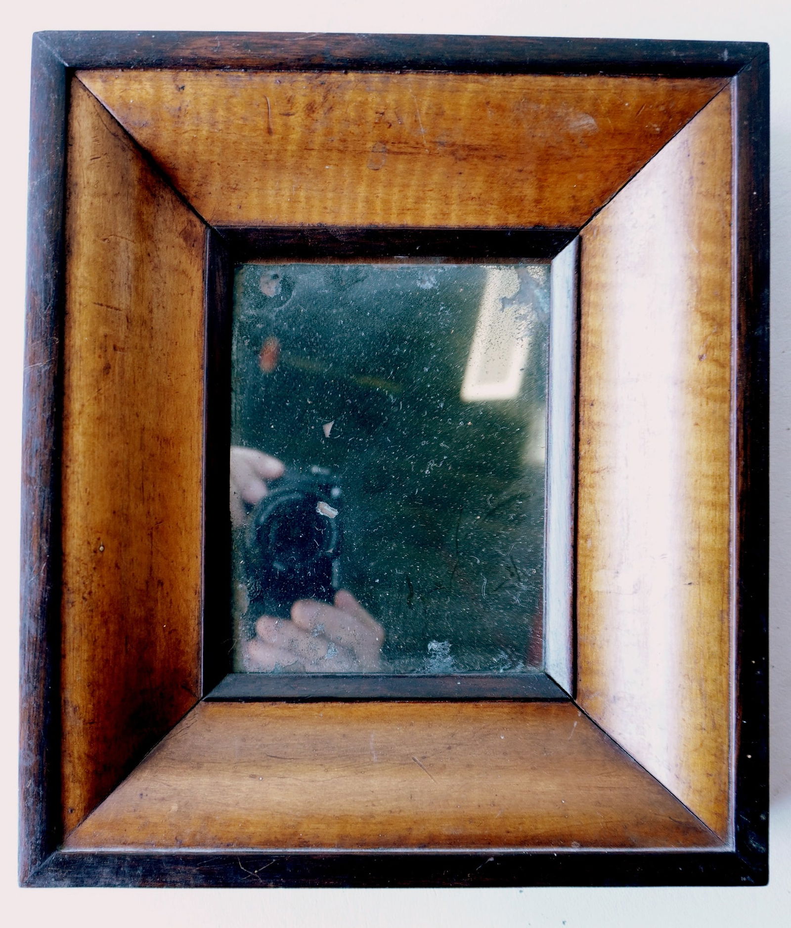 A small tiger maple and walnut mirror, circa 1850-70. Very good condition. Measures 8 3/4"W x 10"H x (1 of 5)