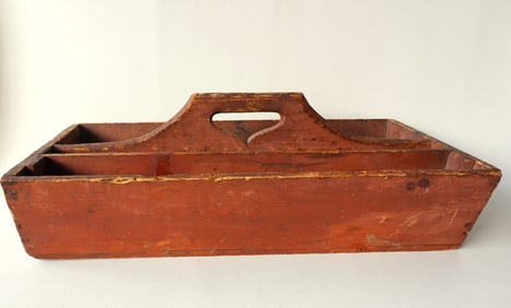 A large primitive wooden tool carrier with a heart cutout handle, square nail construction in