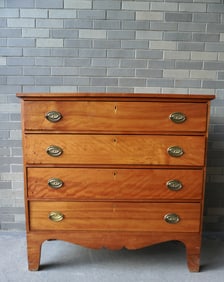A very fine Hepplewhite 4 drawer country chest in figured birch, original high feet separated by a