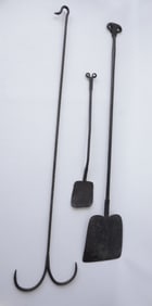 Three hand forged iron hearth items including 2 peels with rams horn finials, and a long handled