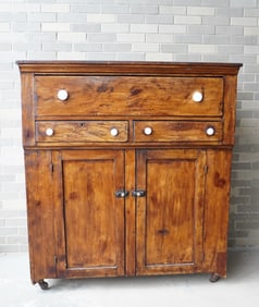 A jelly cupboard having 1 deep drawer over 2 side-by-side drawers over 2 paneled doors on cutout