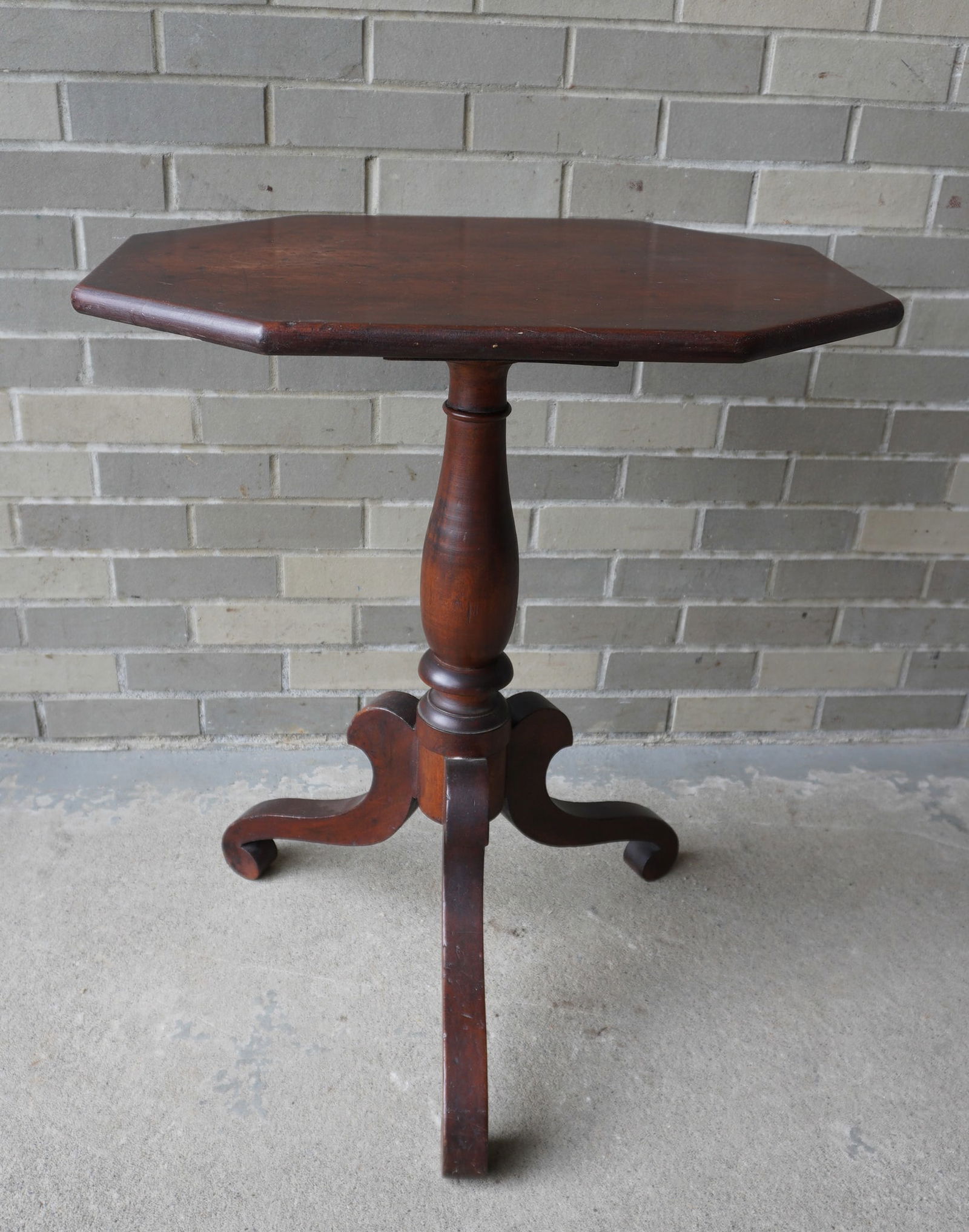 A cherry candlestand with octagonal top over turn pedestal leading to scrolled legs and feet, circa (1 of 7)