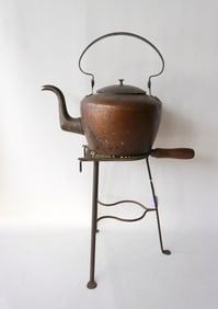 Two hearth items including a trivet with pierced brass top and iron base with penny feet, probably