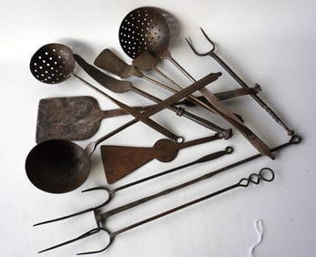 A fine grouping of 12 pieces of early iron kitchen utensils including 2 strainers, 1 ladle, 3