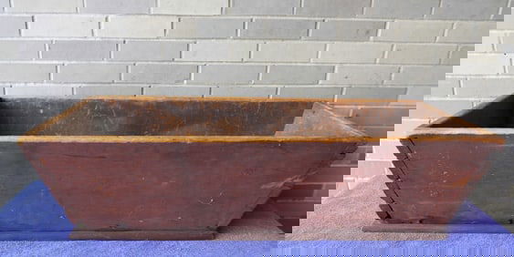 A primitive dovetailed dough box in original red paint, canted sides, early to mid 19th century, no