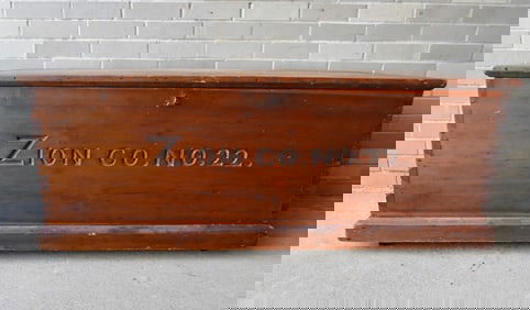 A blanket box with dovetailed sides and molded base, incised across the front "ZION CO. NO. 22.".
