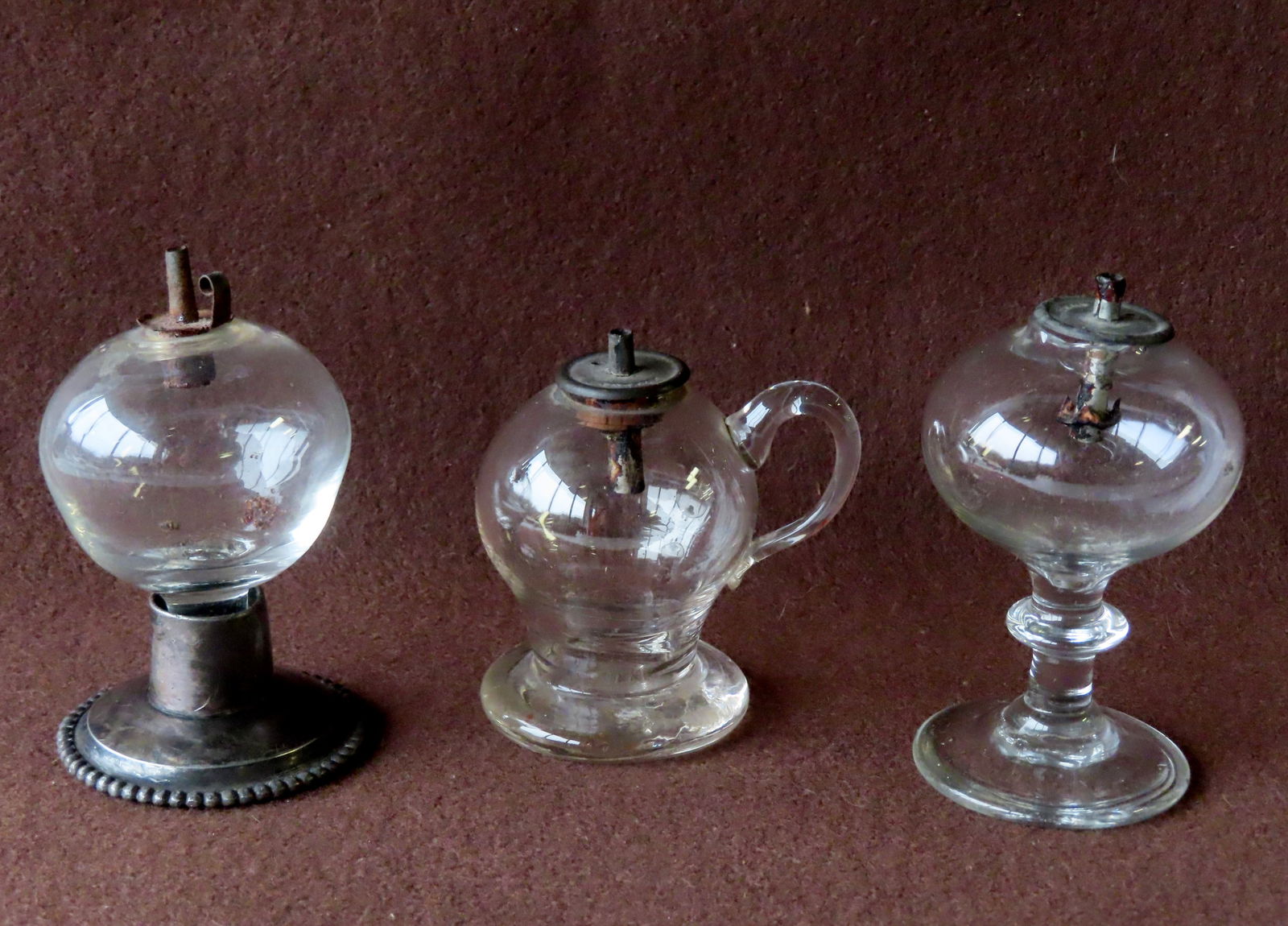 Three hand blown colorless spark lamps, including finger lamp, one attached to turned pedestal, and (1 of 18)
