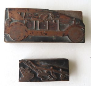 Two brass printing blocks, circa 1920-30, each attached to a wooden block. The first of an