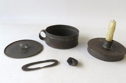 An early combination tin tinder box and chamber stick, with striker, flint, hand made wax candle,