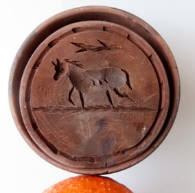 An unusual butter pat of a running horse, 19th century, very good condition. Measures 4 1/2"H x 3