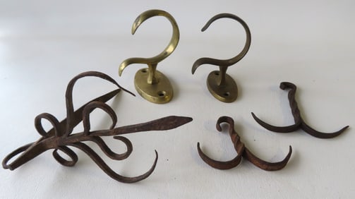 Grouping of 5 early hearth and lighting collectibles including: Matched pair of brass jam hooks,