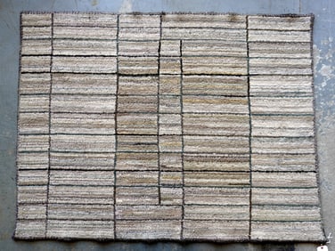 A geometric style hooked rug composed of various size rectangles, late 20th century, excellent