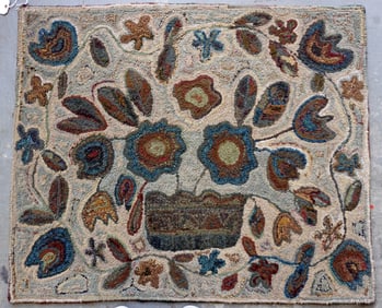 Folk art pictorial hooked rug with a central image of a basket of flowers with a floral and vine