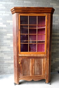 A small size one piece pine corner cupboard with single door with 12 lights (1 light is broken),