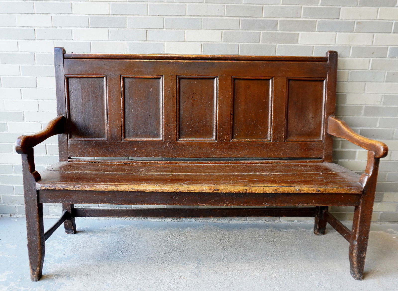 A good early primitive settle bench in original red stain with paneled back, shaped arms, 2 board (1 of 16)